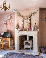 Hand drawn cherubs on plaster walls in snug room with wood burning stove