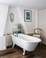 Free standing bath in attic bathroom with recycled wall panelling