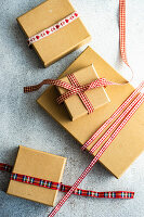 Vintage gift boxes with red and white ribbons on concrete background