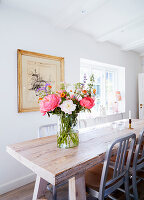 Solid wood dining table with lush bouquet of flowers