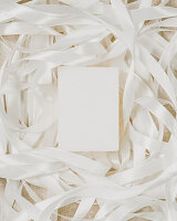 Natural soap in pile of white ribbon