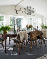 Covered dining table with wicker chairs in the conservatory