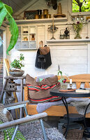 Seating area in greenhouse with wooden extension