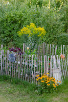 Flower bed in garden with picket fence