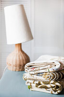 Embroidered tablecloths, table lamp in the background