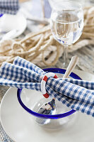 Blue and white place setting, napkin with mini life preserver