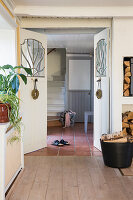Hallway with firewood storage, view through open double doors into the staircase