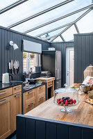 Open kitchen with skylight and grey wood panelling
