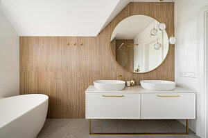 White bathroom in the attic of a detached house with tiles imitating bamboo cladding
