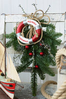 Nautical Christmas decoration with lifebuoy and fir branches