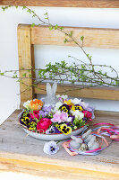 Blumenschale mit Osterhase auf Holzbank