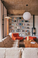 Cozy seating, wooden coffee table, wall of bookshelves and fireplace in a living room
