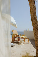 Rattan lounger on terrace with sea view