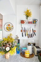 Kitchen with bouquet of flowers and knife holder on the wall