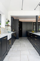 Black and white kitchen with gold-coloured fittings