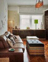 Living room with brown leather sofa and ottoman