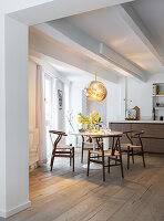 Dining area with wooden table and chairs under a pendant light