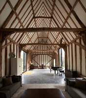 Open living room in a renovated barn with wooden beams