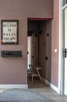 Hallway with pink-coloured paint and modern mural