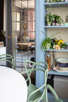 Dining area with designer chairs and glazed sliding door