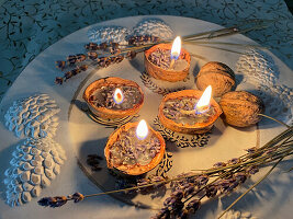 DIY candles with lavender flowers in walnut shells