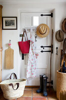 Country-style wardrobe with hats, bag and wellies