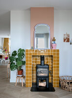 Wood-burning stove surrounded by ochre-colored tiles