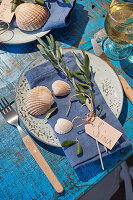 Greek table setting with olive branches and shells