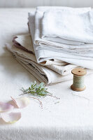 Pile of linen with string and rose petals