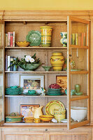 Old-fashioned oak china cabinet with ceramic crockery and decorations