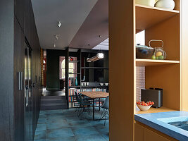 Open-plan kitchen with dining area and blue stone floor tiles