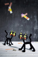 Decorative cats made from black chenille pipe cleaners