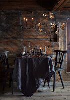Rustic dining area with wooden wall and gilded leaf decoration