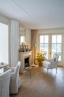 Living room with fireplace, armchair and small Christmas tree