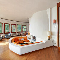 Living room with sunken seating area, many windows and fireplace