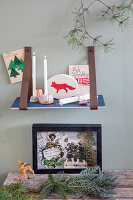 Christmas wall shelf with candles, cards and decorative elements