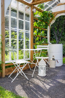 White garden furniture set in the covered greenhouse area