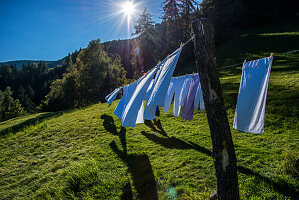 Clothesline with towels on a sunny meadow in the mountains