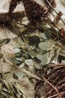 Eucalyptus branches and dried flowers on linen fabric