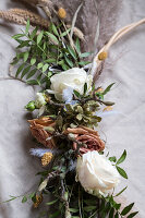 Dried flower bouquet with white roses and green branches