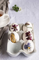 Easter eggs decorated with pressed flowers and leaves