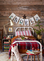 Bedroom decorated for Christmas with garland and presents