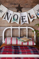 Country-style metal bed with Christmas garland and books
