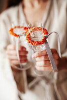 Two champagne glasses decorated with dried orange peel