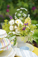 Summer bouquet of flowers with yellow lupins in a vase