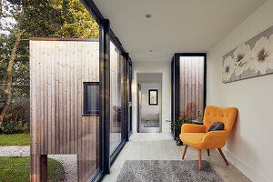 Yellow armchair in the light-flooded hallway with a view outside