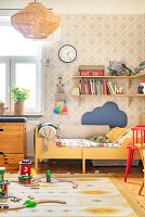 Children's room with wooden toys and patterned wallpaper