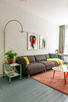 Living room with brown sofa and colourful accents