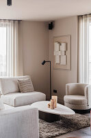 Bright living room with modern cream-coloured furniture and abstract art