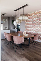 Dining area with oval wooden table and pink velvet chairs